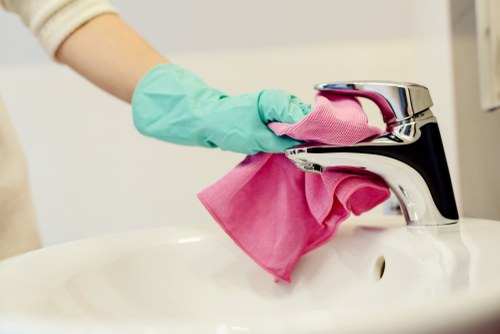 Technician carrying out upholstery cleaning on a fabric sofa