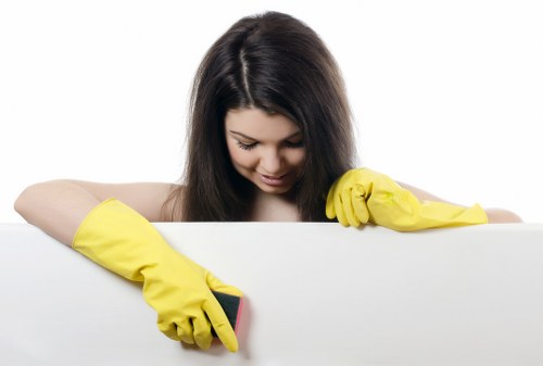 Cleaner dusting and vacuuming in a Camberwell living room